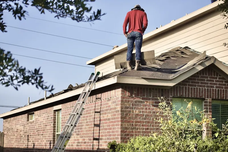 Professional roofer working on a residential roof in Gubser Mill